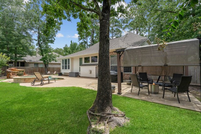 23 Murmuring Creek Pl, The Woodlands, TX 77385 - rear view of property with a fire pit, a patio area, and a shingled roof