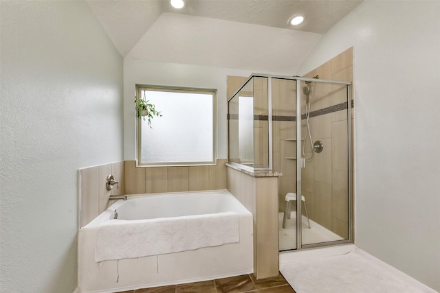 10147 Cimarron Canyon Ln, Magnolia, TX 77354 - full bathroom featuring a bath, lofted ceiling, and a shower stall