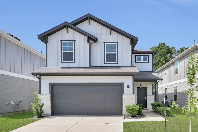 11739 Armadale Dr, Tomball, TX 77375 - view of front of property featuring a garage, concrete driveway, stone siding, board and batten siding, and roof with shingles