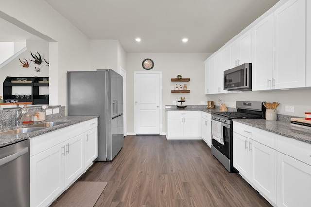 11739 Armadale Dr, Tomball, TX 77375 - kitchen featuring appliances with stainless steel finishes, recessed lighting, dark wood-style flooring, light stone countertops, and white cabinetry