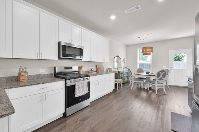 11739 Armadale Dr, Tomball, TX 77375 - kitchen featuring appliances with stainless steel finishes, dark wood finished floors, white cabinetry, recessed lighting, and decorative light fixtures