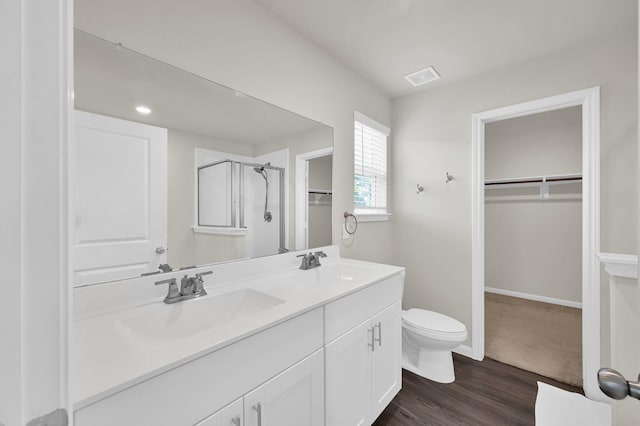 11739 Armadale Dr, Tomball, TX 77375 - bathroom featuring a stall shower, a spacious closet, double vanity, and wood finished floors