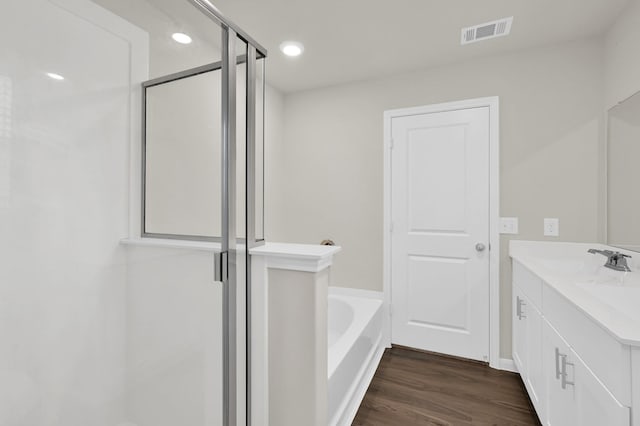 11739 Armadale Dr, Tomball, TX 77375 - bathroom with vanity, a bath, wood finished floors, and a shower with shower door