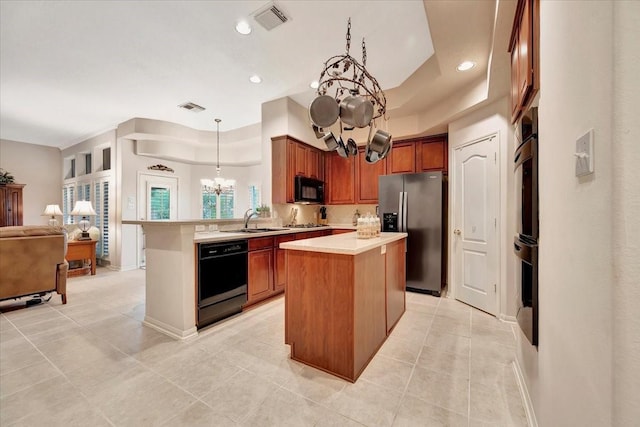 2316 Flagship Ct, League City, TX 77573 - kitchen featuring black appliances, a chandelier, open floor plan, a peninsula, and light tile patterned flooring