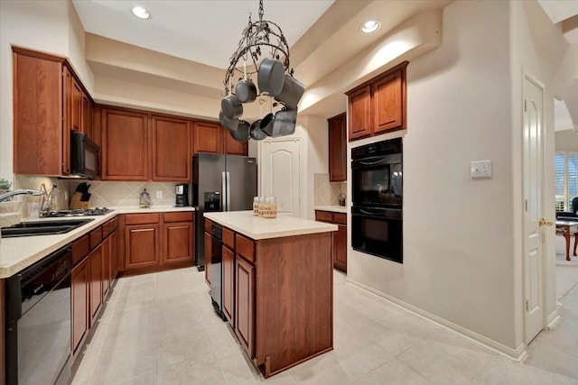 2316 Flagship Ct, League City, TX 77573 - kitchen featuring black appliances, tasteful backsplash, light countertops, a kitchen island, and recessed lighting