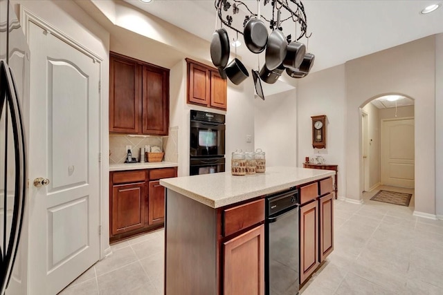 2316 Flagship Ct, League City, TX 77573 - kitchen featuring arched walkways, light tile patterned flooring, decorative backsplash, light countertops, and recessed lighting