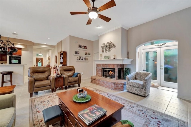2316 Flagship Ct, League City, TX 77573 - living room featuring arched walkways, light tile patterned floors, french doors, ceiling fan, and a fireplace