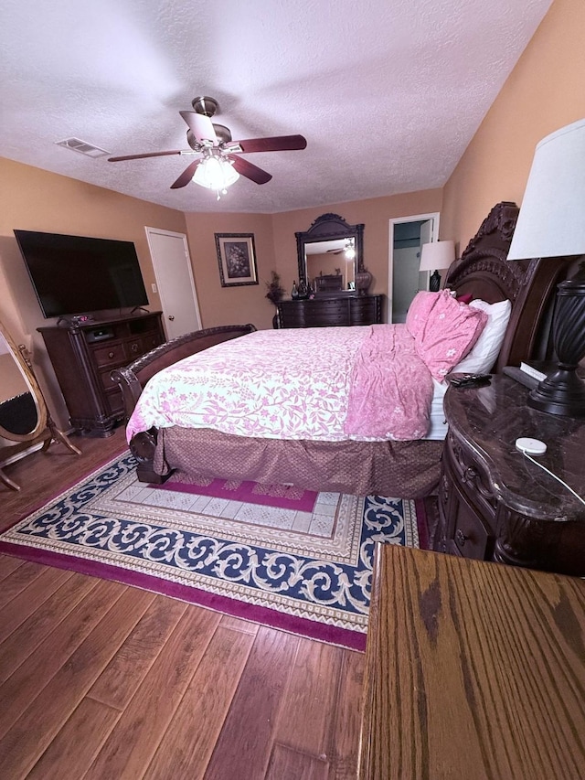 7402 Burkridge Dr, Houston, TX 77041 - bedroom with wood finished floors, a textured ceiling, and a ceiling fan