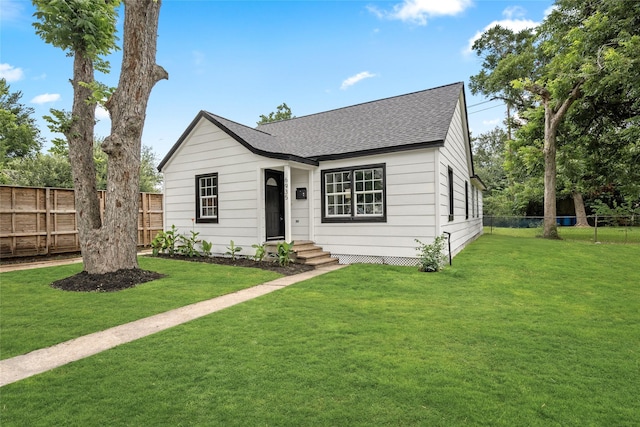 6935 Palmetto St, Houston, TX 77087 - view of front facade with a shingled roof and a fenced backyard