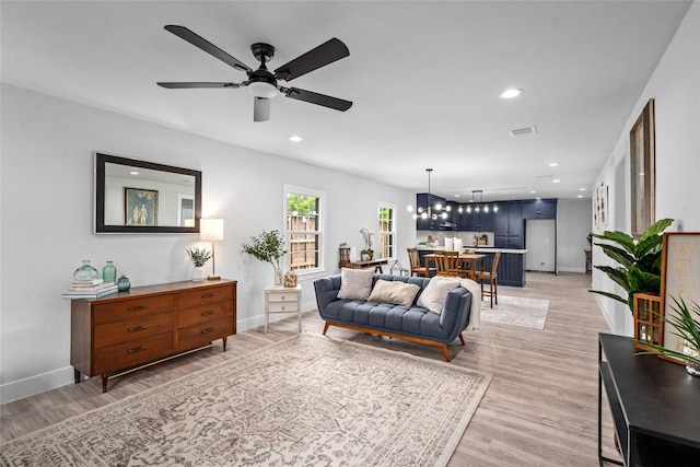 6935 Palmetto St, Houston, TX 77087 - living room with ceiling fan, light wood-type flooring, recessed lighting, and a chandelier
