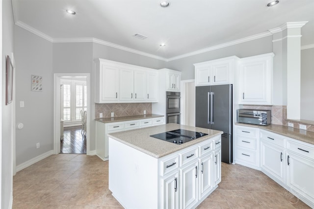4611 Camden Brook Ln, Katy, TX 77494 - kitchen with stainless steel appliances, a kitchen island, decorative backsplash, white cabinetry, and crown molding