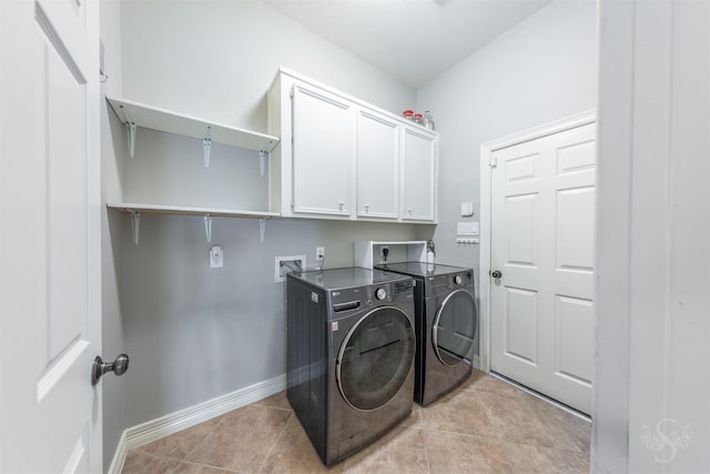 4611 Camden Brook Ln, Katy, TX 77494 - laundry area featuring washer and dryer, cabinet space, and light tile patterned flooring