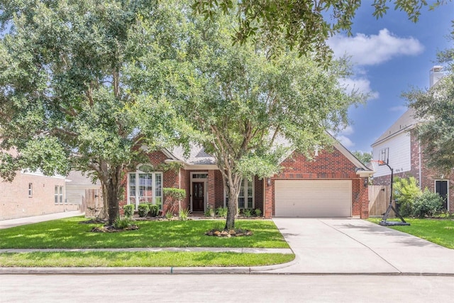 4611 Camden Brook Ln, Katy, TX 77494 - view of property hidden behind natural elements featuring brick siding, a garage, concrete driveway, and a front yard