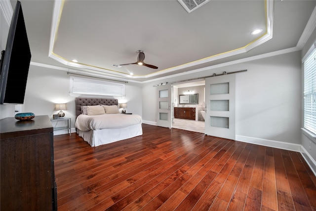 3327 Palm St, Houston, TX 77004 - bedroom with a tray ceiling, a barn door, wood-type flooring, crown molding, and connected bathroom