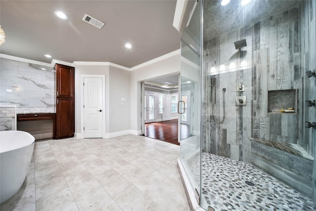 3327 Palm St, Houston, TX 77004 - bathroom featuring ornamental molding, a shower stall, a freestanding tub, and recessed lighting