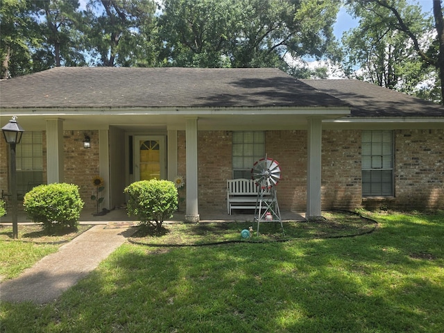 26718 Eastwood Dr, Cat Spring, TX 77386 - view of front of property with a porch, brick siding, and a front lawn
