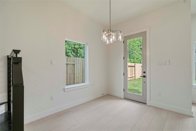 4505 Phlox St, Houston, TX 77051 - unfurnished dining area with a chandelier, plenty of natural light, and wood finished floors
