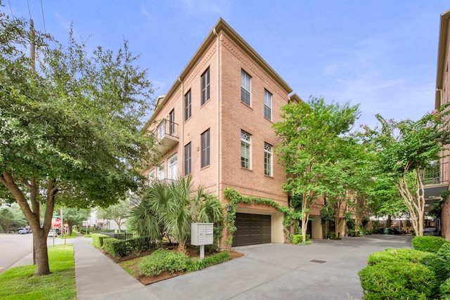 1801 Ashland St, Houston, TX 77008 - view of building exterior with a garage and concrete driveway