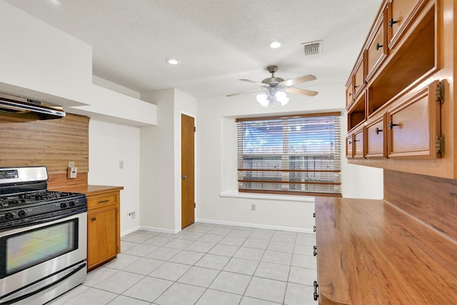 4418 Talina Way, Houston, TX 77041 - kitchen featuring stainless steel gas stove, butcher block countertops, a ceiling fan, tasteful backsplash, and brown cabinetry