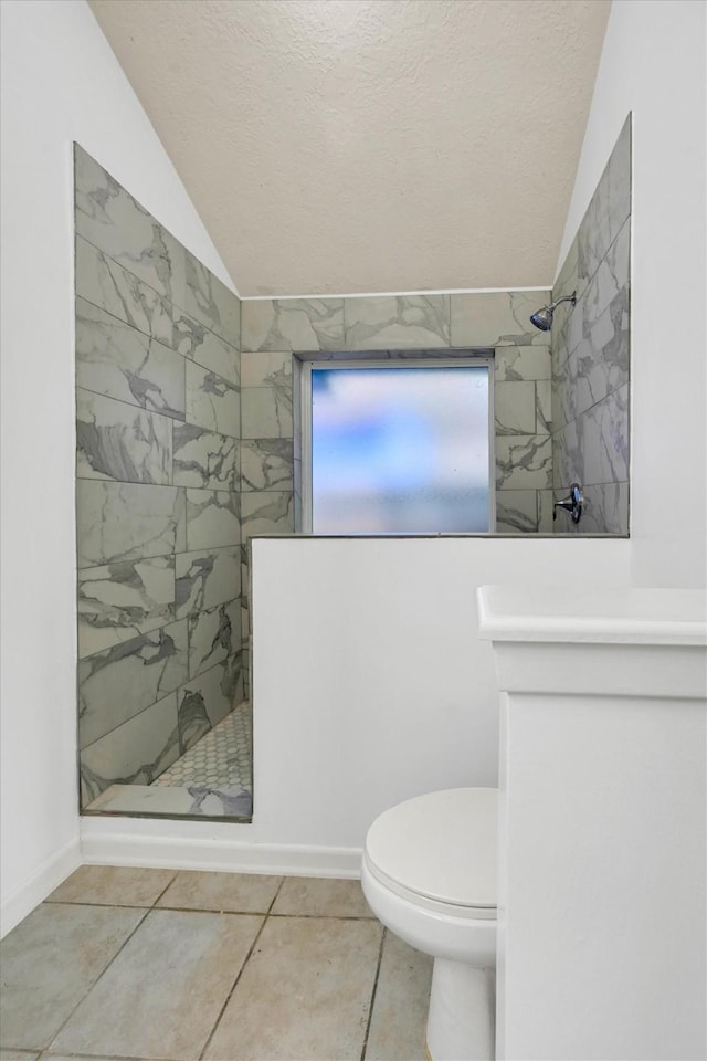 4418 Talina Way, Houston, TX 77041 - full bathroom featuring lofted ceiling, tiled shower, a textured ceiling, and tile patterned floors