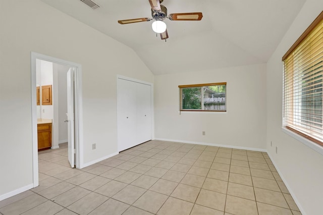 4418 Talina Way, Houston, TX 77041 - unfurnished bedroom featuring vaulted ceiling, light tile patterned flooring, ceiling fan, and a closet