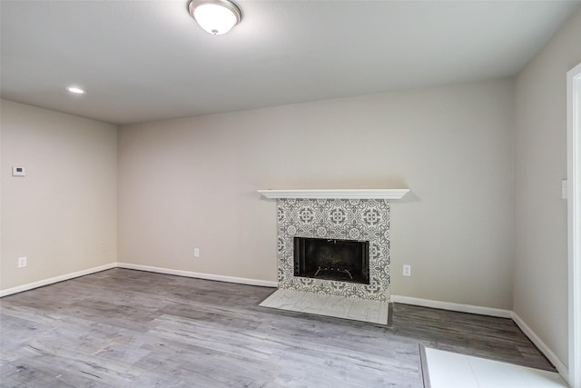 3300 Pebblebrook Dr Unit 15, Seabrook, TX 77586 - unfurnished living room with wood finished floors, a tile fireplace, and recessed lighting