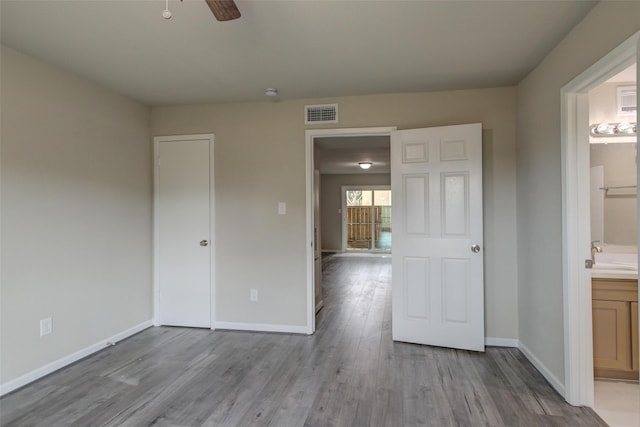 3300 Pebblebrook Dr Unit 15, Seabrook, TX 77586 - unfurnished bedroom with wood finished floors, ensuite bathroom, and a ceiling fan