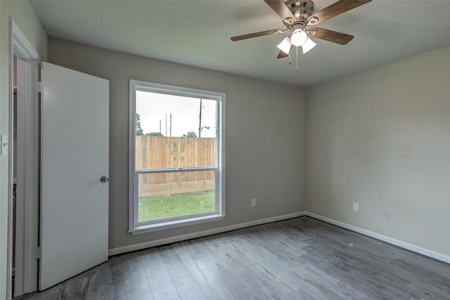 3300 Pebblebrook Dr Unit 15, Seabrook, TX 77586 - empty room featuring healthy amount of natural light, wood finished floors, and ceiling fan