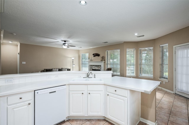 2603 Piney Woods Dr, Pearland, TX 77581 - kitchen with dishwasher, a fireplace, ceiling fan, light tile patterned flooring, and open floor plan