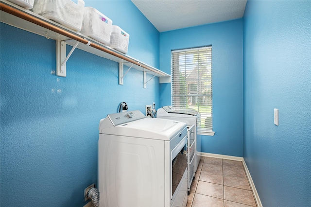 2603 Piney Woods Dr, Pearland, TX 77581 - washroom featuring washer and clothes dryer and light tile patterned floors