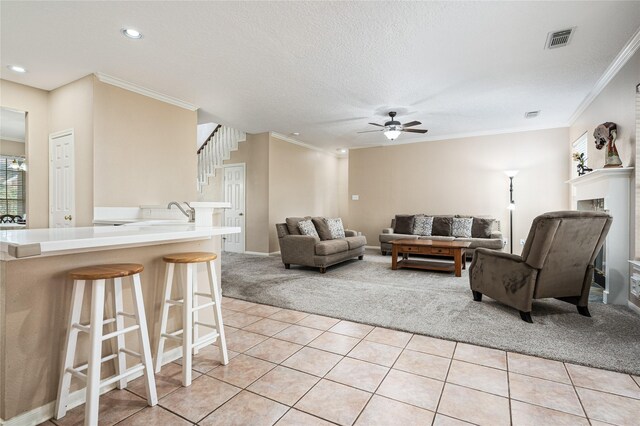 2603 Piney Woods Dr, Pearland, TX 77581 - living room with light carpet, a ceiling fan, ornamental molding, light tile patterned flooring, and recessed lighting