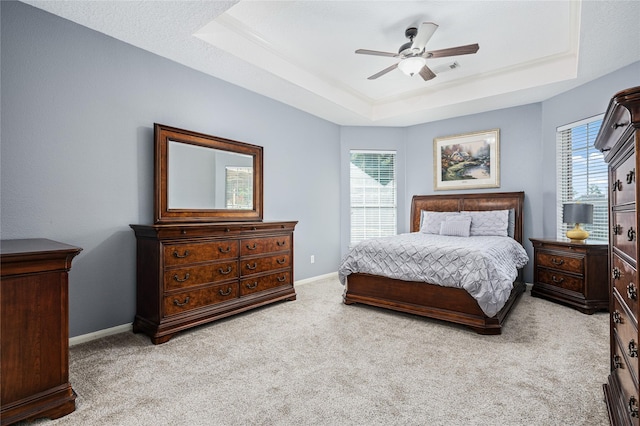 2603 Piney Woods Dr, Pearland, TX 77581 - carpeted bedroom with a tray ceiling and a ceiling fan