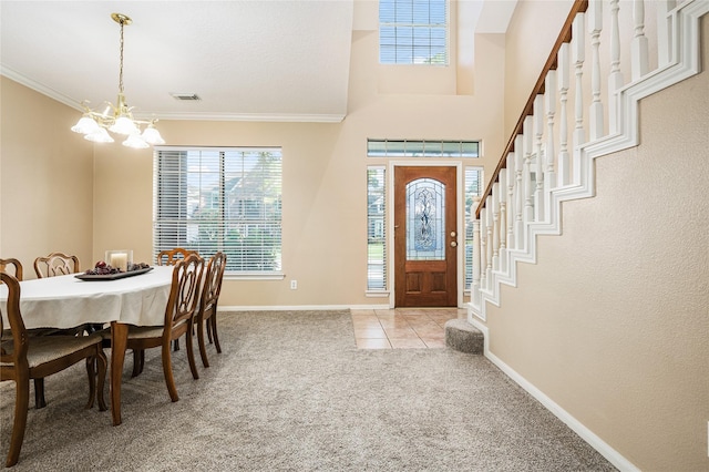 2603 Piney Woods Dr, Pearland, TX 77581 - carpeted foyer with healthy amount of natural light, a chandelier, ornamental molding, tile patterned floors, and stairs