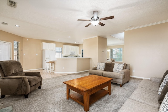 2603 Piney Woods Dr, Pearland, TX 77581 - living area with a ceiling fan, light colored carpet, recessed lighting, ornamental molding, and a textured ceiling