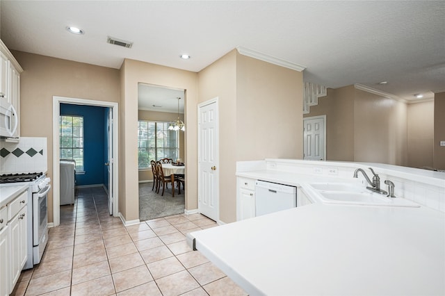 2603 Piney Woods Dr, Pearland, TX 77581 - kitchen featuring white appliances, light countertops, light tile patterned floors, decorative backsplash, and white cabinetry