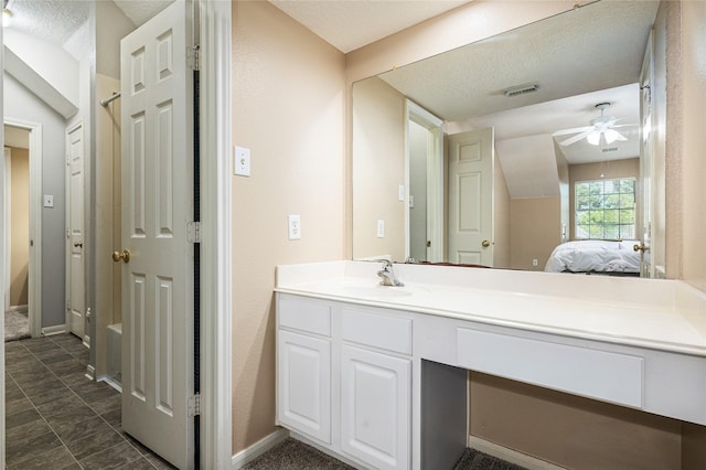 2603 Piney Woods Dr, Pearland, TX 77581 - bathroom with vanity, ceiling fan, ensuite bath, lofted ceiling, and a textured ceiling