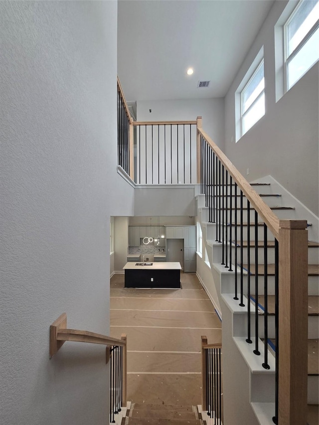 3404 Rawley St, Houston, TX 77020 - staircase featuring a high ceiling and recessed lighting