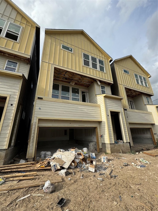 5107 Ave J, Houston, TX 77011 - view of front of house featuring an attached garage and board and batten siding