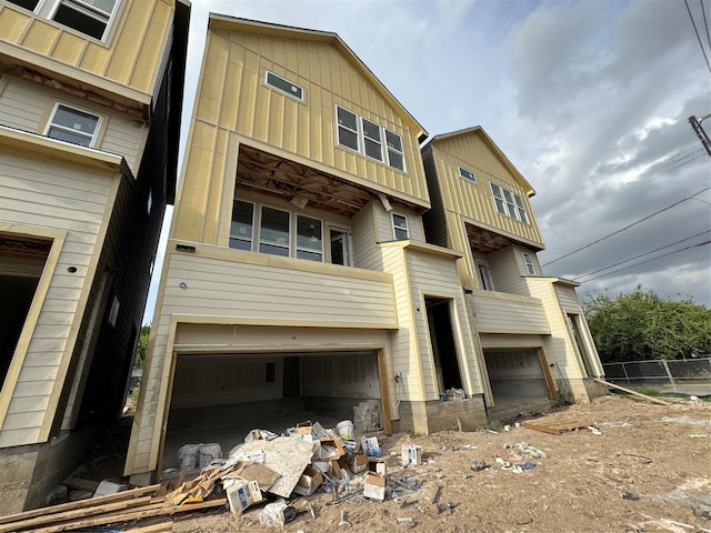 5107 Ave J, Houston, TX 77011 - view of front of house with board and batten siding and an attached garage