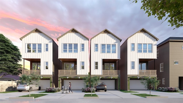 5107 Ave J, Houston, TX 77011 - view of front of home featuring an attached garage, board and batten siding, and driveway