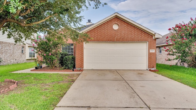2319 Blue Reef Dr, Katy, TX 77449 - view of front of property with brick siding, driveway, a chimney, an attached garage, and a front lawn