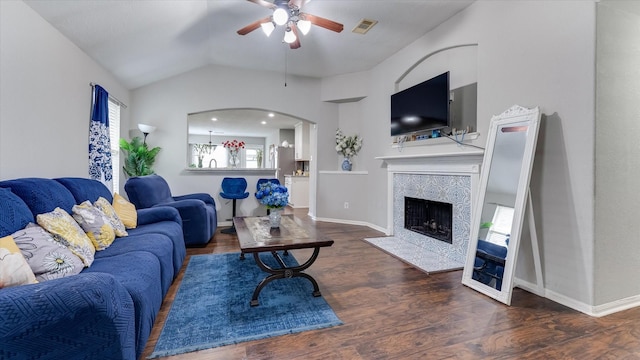 2319 Blue Reef Dr, Katy, TX 77449 - living area with a ceiling fan, lofted ceiling, a tiled fireplace, arched walkways, and wood finished floors