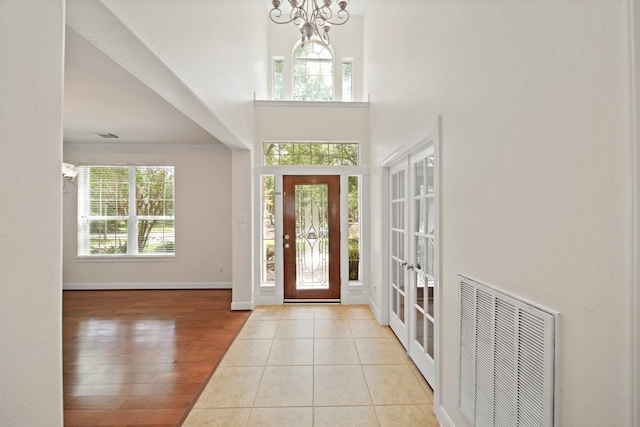 4802 N Pine Brook Way, Houston, TX 77059 - foyer entrance with healthy amount of natural light, a towering ceiling, wood finished floors, and a chandelier