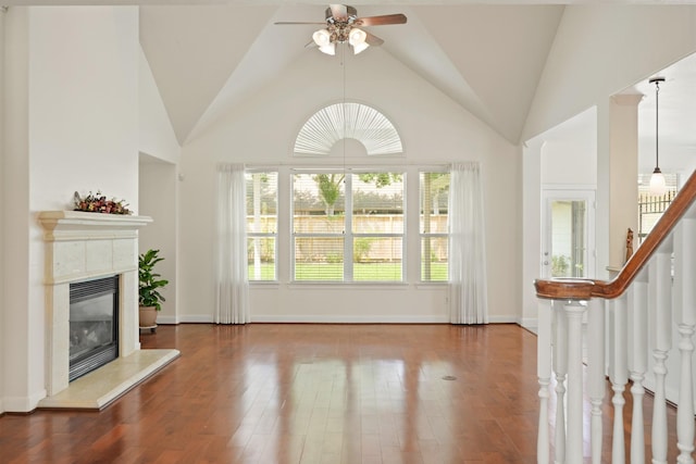 4802 N Pine Brook Way, Houston, TX 77059 - unfurnished living room with a ceiling fan, a fireplace, vaulted ceiling, wood finished floors, and stairway