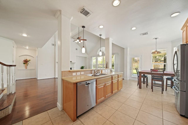 4802 N Pine Brook Way, Houston, TX 77059 - kitchen with stainless steel appliances, light countertops, light tile patterned floors, pendant lighting, and ceiling fan