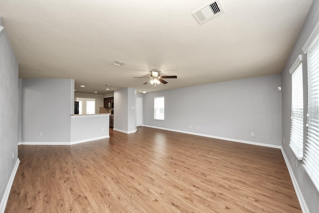 9914 Swallow Dr, Conroe, TX 77385 - unfurnished living room featuring ceiling fan and dark wood finished floors