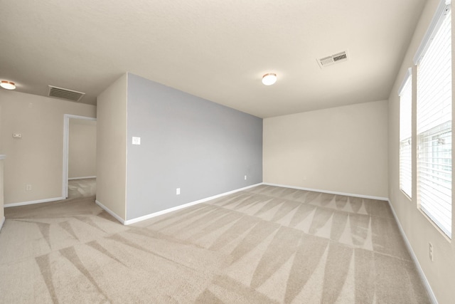 9914 Swallow Dr, Conroe, TX 77385 - spare room featuring carpet and plenty of natural light