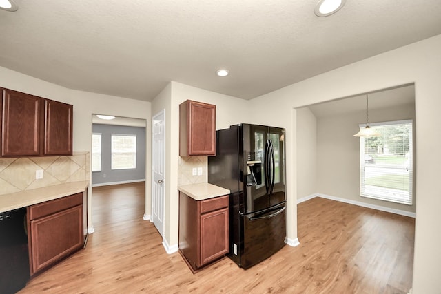 9914 Swallow Dr, Conroe, TX 77385 - kitchen featuring black appliances, light wood-style floors, light countertops, tasteful backsplash, and recessed lighting