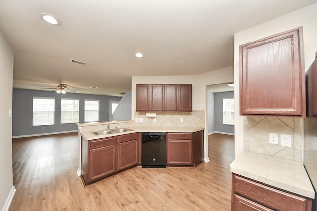 9914 Swallow Dr, Conroe, TX 77385 - kitchen with black dishwasher, light wood-type flooring, light countertops, plenty of natural light, and recessed lighting