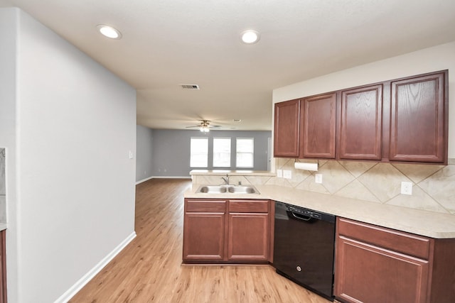 9914 Swallow Dr, Conroe, TX 77385 - kitchen featuring black dishwasher, light wood-type flooring, tasteful backsplash, light countertops, and recessed lighting